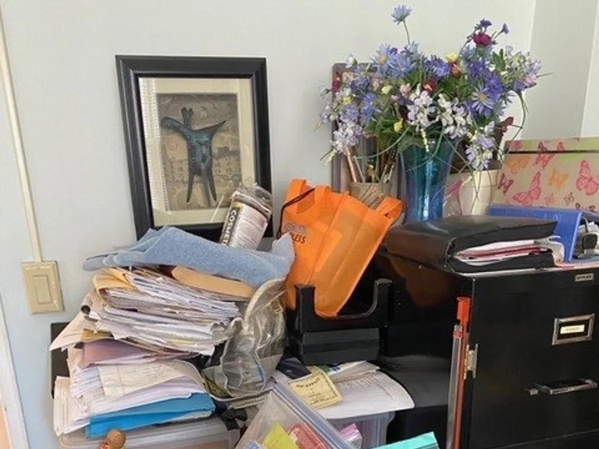 A cluttered home office corner before organizing